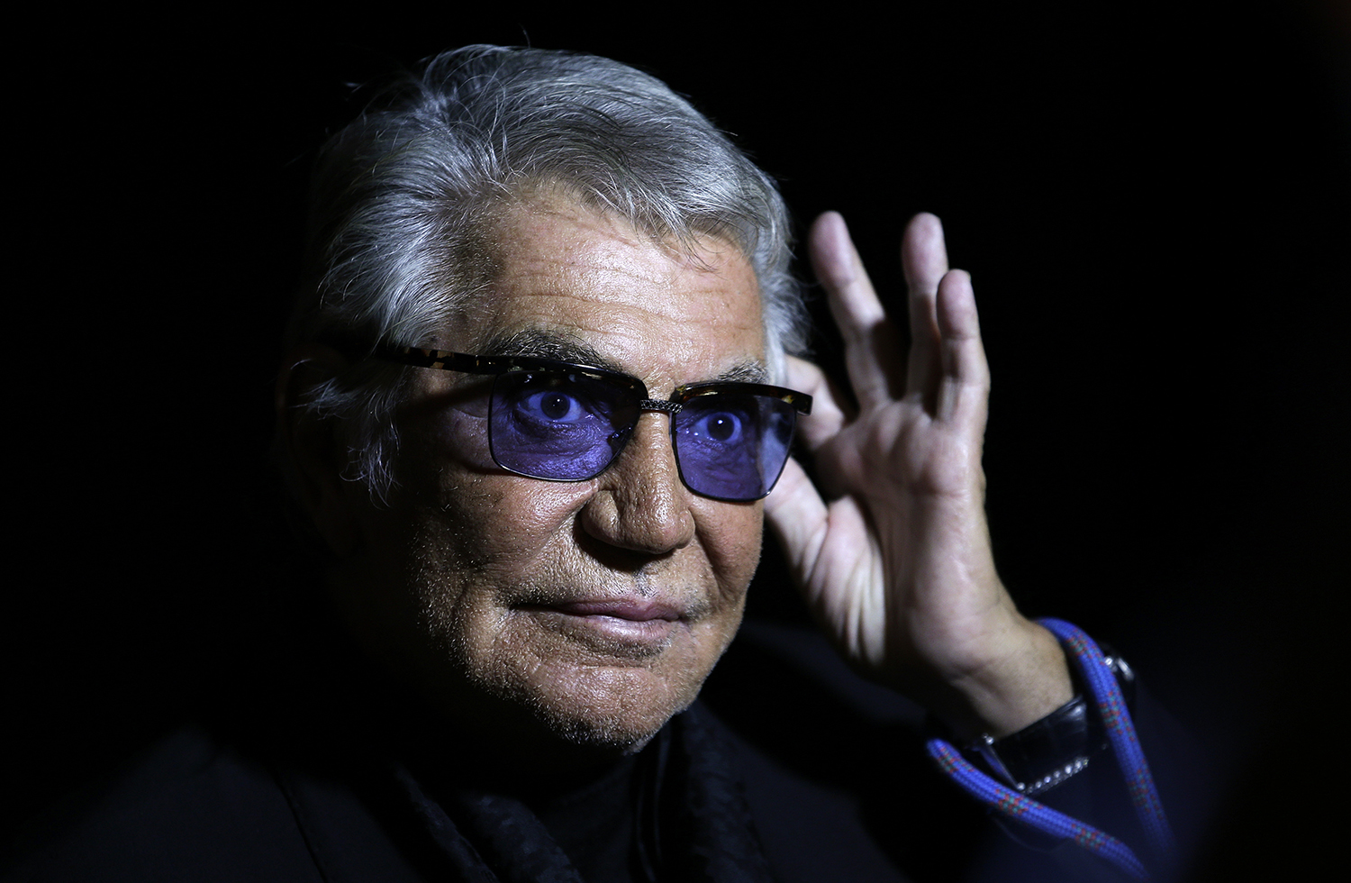 Cavalli acknowledges the audience at the end of his Spring/Summer 2014 collection during Milan Fashion Week