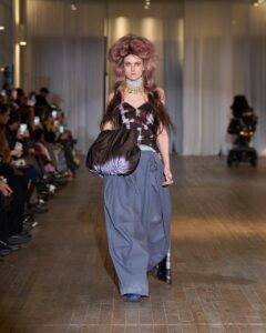 Collina Strada runway review, Hillary Taymour designer, NYFW Fall 2026 highlights, vampire runway theme, dark romance fashion trend, sustainable ready-to-wear, eco-conscious fashion brands, gothic fashion narrative, upcycled luxury materials, independent American designers, fashion storytelling 2026, ethical fashion leadership, New York Fashion Week analysis, fantastical fashion tale, modern gothic aesthetic, luxury sustainability movement, runway magazine fashion authority, future of ready-to-wear, editorial fashion critique, luxury fashion innovation