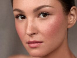 Model wearing boyfriend blush trend makeup with naturally flushed cheeks and soft skin-focused beauty styling