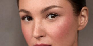 Model wearing boyfriend blush trend makeup with naturally flushed cheeks and soft skin-focused beauty styling