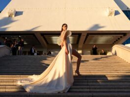Model in a sculptural ivory silk gown ascending the Cannes Film Festival red carpet steps at golden hour representing the best dressed looks at Cannes 2026