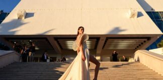 Model in a sculptural ivory silk gown ascending the Cannes Film Festival red carpet steps at golden hour representing the best dressed looks at Cannes 2026