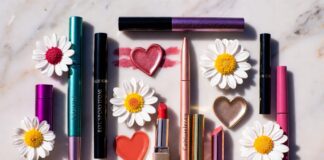Marc Jacobs Beauty’s Sephora Return Is Fueling Massive Makeup Nostalgia Editorial flatlay of bold luxury makeup products with charm-motif packaging representing the Marc Jacobs Beauty Sephora return and maximalist relaunch collection launching June 1 2026