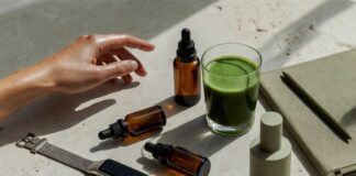 The Longevity Lifestyle: How Biohacking Went Mainstream in 2026 Curated wellness lifestyle flat lay with wearable tracker, supplement bottles, green smoothie, and skincare serum representing the longevity biohacking movement in 2026