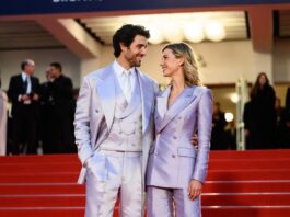Barbara Palvin Sprouse in a Miu Miu gown with Dylan Sprouse in a double-breasted suit on the Cannes 2026 red carpet at the Parallel Tales premiere where they announced their first pregnancy.