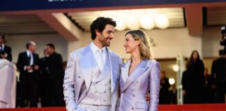 Barbara Palvin Sprouse in a Miu Miu gown with Dylan Sprouse in a double-breasted suit on the Cannes 2026 red carpet at the Parallel Tales premiere where they announced their first pregnancy.
