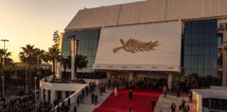 Guests ascending the Cannes Palais des Festivals red carpet steps at golden hour representing the Cannes Film Festival 2026 Oscar buzz and prestige film awards season