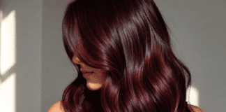 Cherry Cola Hair Color Is Dominating Celebrity Hair Transformations This Season Cinematic editorial close-up of glossy cherry cola hair in deep burgundy-brunette tones with warm red highlights representing the most requested celebrity hair color trend of 2026