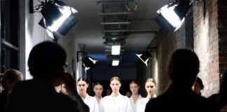 Fashion week models lined up backstage before a runway show, illustrating who gets booked for fashion week and why