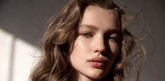 Model with natural textured hair featuring invisible ghost layers and soft, effortless movement in a beauty editorial setting.