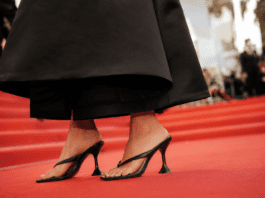 Alaïa heeled flip-flop sandals worn with a drop-waist little black dress on the Cannes Film Festival 2026 red carpet — confirming the heeled thong sandal as the shoe trend of summer 2026.