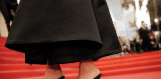 Alaïa heeled flip-flop sandals worn with a drop-waist little black dress on the Cannes Film Festival 2026 red carpet — confirming the heeled thong sandal as the shoe trend of summer 2026.