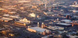 Aerial view of Hollywood studio backlot at golden hour representing the Warner Bros merger and Paramount Skydance $110 billion acquisition reshaping entertainment industry power in 2026