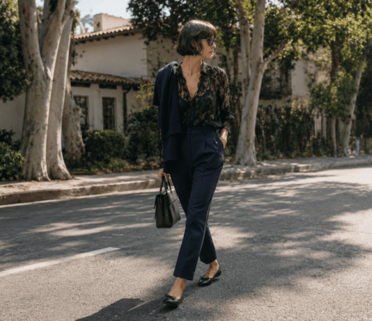 Kaia Gerber’s Minimalist Street Style Is Defining the New Model-Off-Duty Uniform Kaia Gerber in a minimalist off-duty outfit featuring a black lacy blouse, navy tailored trousers, and black ballet flats on a Los Angeles street in 2026.