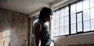 London Fashion Week Emerging Designers to Watch 2026 Model in a sculptural layered look walking an intimate London Fashion Week runway show, representing Runway Magazine's emerging designers to watch for Autumn Winter 2026