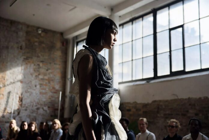 London Fashion Week Emerging Designers to Watch 2026 — Runway Magazine Model in a sculptural layered look walking an intimate London Fashion Week runway show, representing Runway Magazine's emerging designers to watch for Autumn Winter 2026