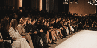 Milan Fashion Week: Front Row Power Players Editors and guests seated front row at a Milan Fashion Week runway show, representing the power players and seating hierarchy covered by Runway Magazine's Spring 2026 front row profile