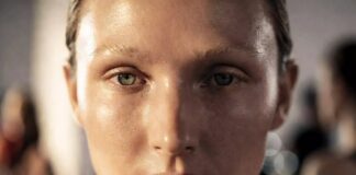 Model with luminous no-makeup makeup look showing natural skin texture and barely there coverage, representing Runway Magazine's guide to the no-makeup makeup look's runway origins and step-by-step recreation