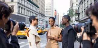 NYFW Street Style: The Best Looks Outside the Shows Fashion week attendees in tailored architectural street style looks on the pavement outside a New York Fashion Week venue, representing Runway Magazine's best NYFW street style Spring 2026 coverage