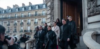 Paris Fashion Week: The Ultimate Attendee Guide Elegantly dressed fashion professionals arriving at a Paris Fashion Week show venue, illustrating the Paris Fashion Week attendee guide by Runway Magazine