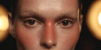 Runway Makeup Trends 2026: The Looks Defining the Season Model with runway makeup trends 2026 showing flushed skin and blurred lip representing Runway Magazine's complete breakdown of the season's five defining beauty directions