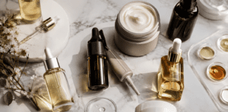 Premium scalp care and biotech haircare products arranged on marble surface in editorial flat lay