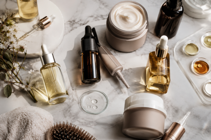 Scalp Care Trend — Luxury Haircare Products 2026 Premium scalp care and biotech haircare products arranged on marble surface in editorial flat lay