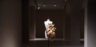 Sculptural couture piece on a dress form in a gallery setting representing Schiaparelli surrealism and the house's most iconic avant-garde designs covered by Runway Magazine