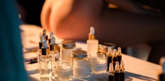 Luxury skincare products arranged on a backstage beauty table at a fashion week show, representing the runway model skincare secrets and routines revealed by Runway Magazine