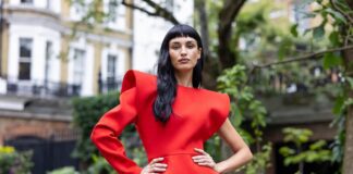 Bold sculptural fashion editorial image evoking the Topshop SS26 Le Jardin campaign fronted by Adwoa Aboah featuring statement silhouettes in vivid red and electric blue representing British fashion icon Topshop comeback 2026 and fashion campaign authority