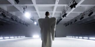 Model in architectural oversized Balenciaga coat on a stark runway representing Demna Balenciaga collections and the controversial creative tenure documented in Runway Magazine's complete guide