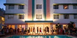 PARAISO’s Poolside Runways Are Redefining Fashion Week Spectacle Models on a runway built over an Art Deco hotel pool in warm evening light representing PARAISO RISE Miami Swim Week 2026 at the Kimpton Surfcomber Hotel and the immersive fashion experience format redefining pool runway fashion shows