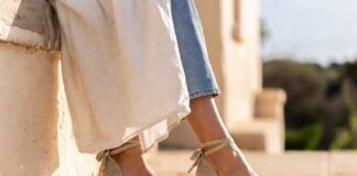 Princess Diana’s Favorite Summer Shoe Is Suddenly Everywhere Again in 2026 Woman wearing natural raffia wedge espadrilles in Mediterranean coastal light representing the wedge espadrilles 2026 trend and Princess Diana fashion royal style inspiration behind summer shoe trends 2026